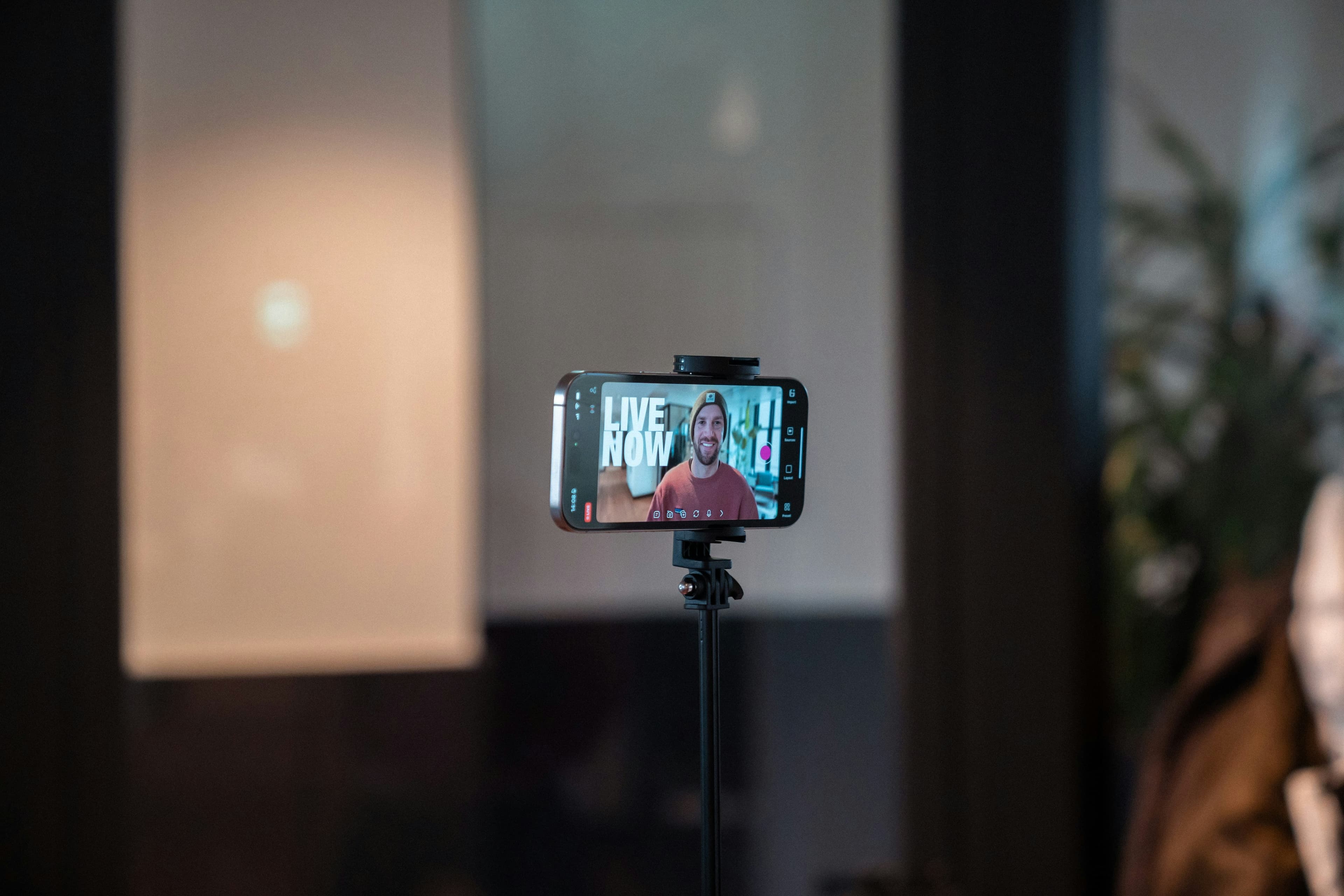 Un smartphone sur un trépied filmant un créateur de contenu vidéo