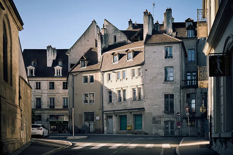 Une rue de ville avec de beaux bâtiments illustrant l'histoire et l'architecture d'un quartier