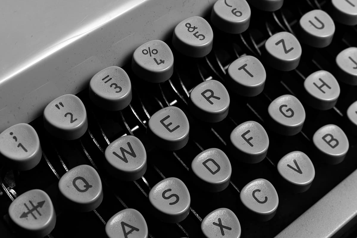 Une machine à écrire vintage sur fond noir, illustrant la mécanique de la structuration des mots